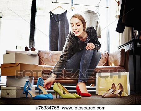 Stock Photo - Woman trying on high heeled shoes. Fotosearch