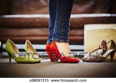 Stock Photography - Woman trying on high heeled shoes. Fotosearch