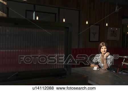Woman with coffee alone in restaurant View Large Photo Image Stock Photo - Woman with coffee alone in restaurant. Fotosearch