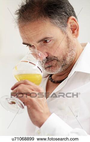 Stock Photo - Worker in brewery, quality control. Fotosearch