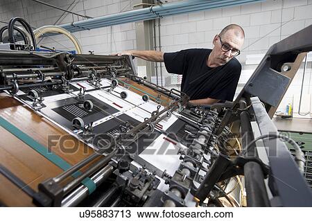 Worker monitoring print machine in printing workshop View Large Photo Image Stock Image - Worker monitoring print machine in printing workshop. Fotosearch