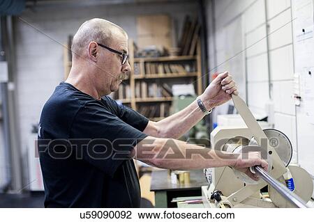 Worker operating cutting machine in paper printing workshop View Large Photo Image Stock Image - Worker operating cutting machine in paper printing workshop. Fotosearch
