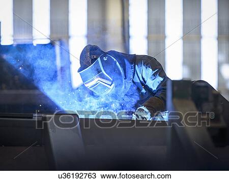 Worker welding in factory View Large Photo Image Stock Image - Worker welding in factory. Fotosearch