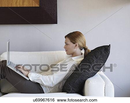 Young businesswoman using laptop in hotel room View Large Photo Image Stock Photograph - Young businesswoman using laptop in hotel room. Fotosearch