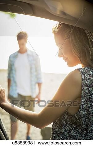 Young couple by car View Large Photo Image Stock Image - Young couple by car. Fotosearch