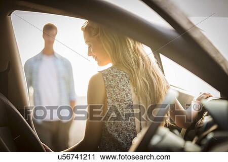 Stock Image - Young couple by car. Fotosearch