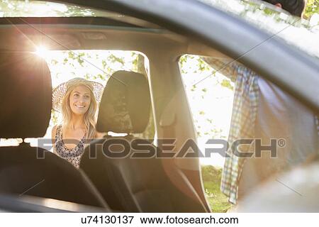 Young couple by car View Large Photo Image Stock Photo - Young couple by car. Fotosearch