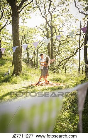 Stock Photo - Young couple dancing in forest. Fotosearch