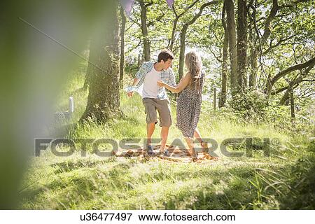 Young couple dancing in forest View Large Photo Image Stock Photo - Young couple dancing in forest. Fotosearch