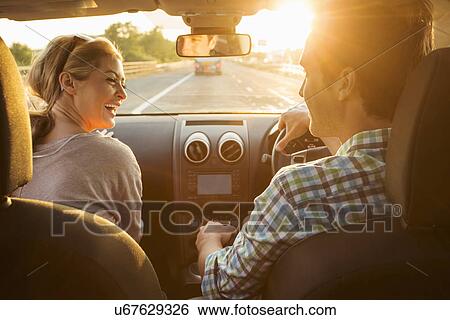 Stock Photograph - Young couple driving in car. Fotosearch