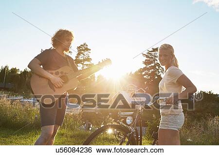 Young couple enjoying guitar, Gavle, Sweden View Large Photo Image Stock Photograph - Young couple enjoying guitar, Gavle, Sweden. Fotosearch