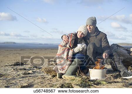 Stock Photo - Young couple having bbq on beach, Brean Sands, Somerset, England. Fotosearch