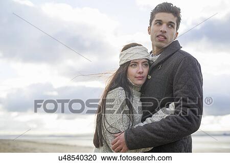 Young couple hugging, Brean Sands, Somerset, England View Large Photo Image Stock Image - Young couple hugging, Brean Sands, Somerset, England. Fotosearch