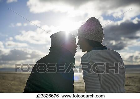 Young couple kissing in sunlight, Brean Sands, Somerset, England View Large Photo Image Stock Photograph - Young couple kissing in sunlight, Brean Sands, Somerset, England. Fotosearch