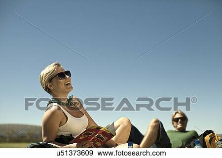 Stock Photo - Young couple reclining in park, Cape Town, South Africa. Fotosearch