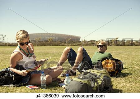 Young couple reclining in park with maps, Cape Town, South Africa View Large Photo Image Stock Photo - Young couple reclining in park with maps, Cape Town, South Africa. Fotosearch