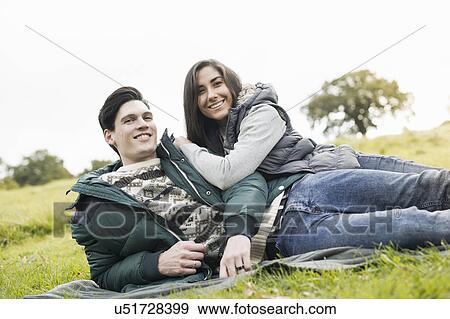Young couple resting in park View Large Photo Image Stock Photo - Young couple resting in park. Fotosearch
