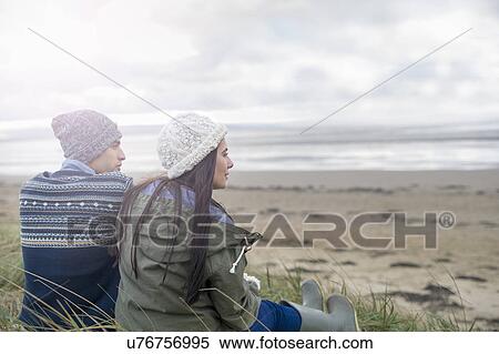 Young couple sitting on beach, Brean Sands, Somerset, England View Large Photo Image Stock Photography - Young couple sitting on beach, Brean Sands, Somerset, England. Fotosearch