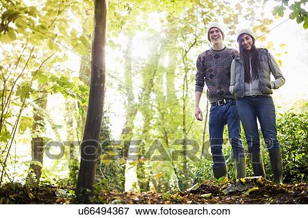 Young couple walking in forest View Large Photo Image Stock Photo - Young couple walking in forest. Fotosearch