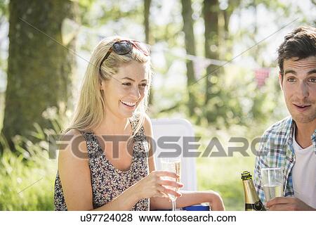 Young couple with champagne in forest View Large Photo Image Stock Photo - Young couple with champagne in forest. Fotosearch