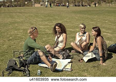 Young friends sitting in park with maps, Cape Town, South Africa View Large Photo Image Stock Photography - Young friends sitting in park with maps, Cape Town, South Africa. Fotosearch