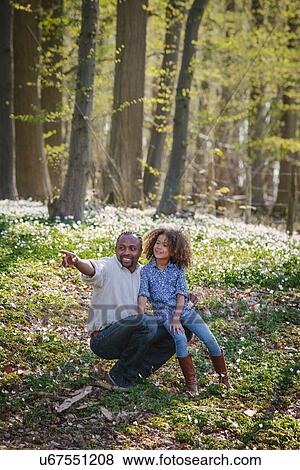 Young girl and father in woods View Large Photo Image Stock Photo - Young girl and father in woods. Fotosearch