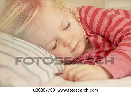 Young girl asleep in bed View Large Photo Image Stock Photo - Young girl asleep in bed. Fotosearch