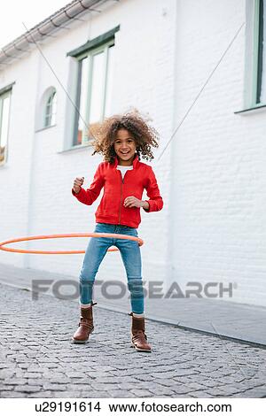 Young girl practicing with hoola hoop View Large Photo Image Picture - Young girl practicing with hoola hoop. Fotosearch