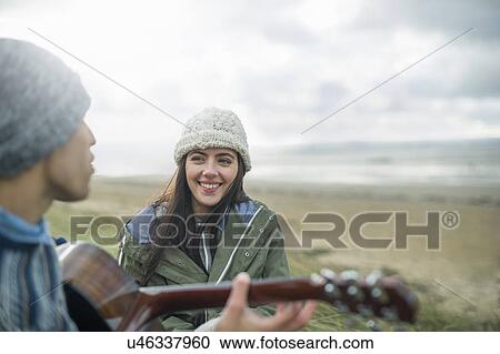 Young man playing guitar, Brean Sands, Somerset, England View Large Photo Image Stock Image - Young man playing guitar, Brean Sands, Somerset, England. Fotosearch