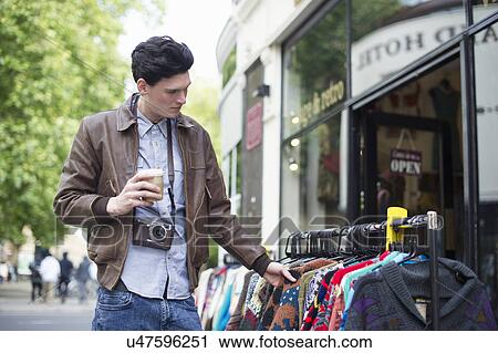 Stock Image - Young man shopping. Fotosearch