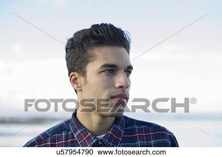 Stock Image - Young man wearing checked shirt. Fotosearch