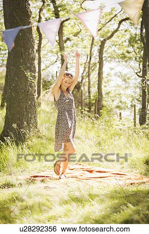 Young woman dancing in forest View Large Photo Image Stock Photograph - Young woman dancing in forest. Fotosearch