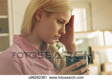 Young woman holding hot drink View Large Photo Image Stock Image - Young woman holding hot drink. Fotosearch