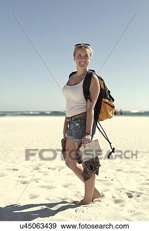 Stock Photo - Young woman on coastline, Cape Town, South Africa. Fotosearch