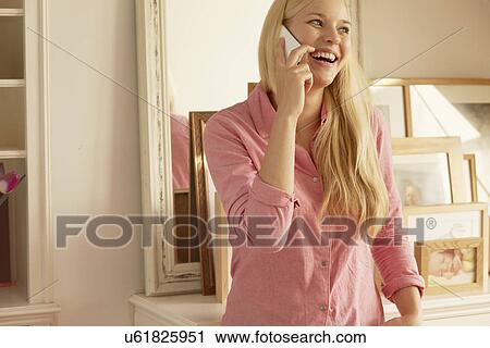 Stock Image - Young woman on telephone call. Fotosearch