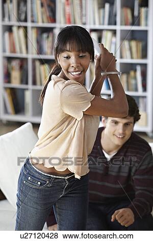 Young woman playing video game View Large Photo Image Stock Photo - Young woman playing video game. Fotosearch