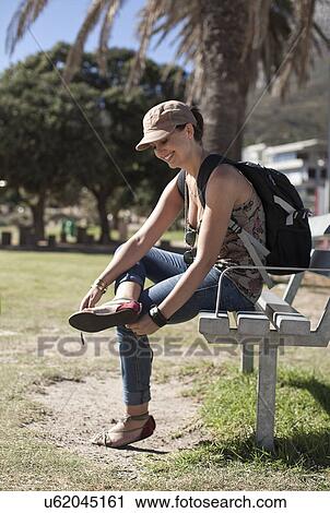 Young woman taking a break on park bench, Cape Town, South Africa View Large Photo Image Stock Image - Young woman taking a break on park bench, Cape Town, South Africa. Fotosearch