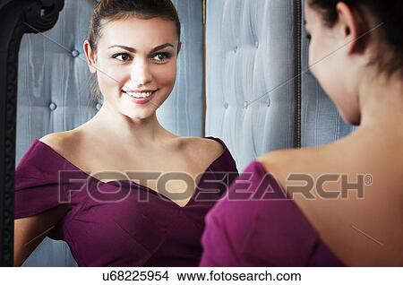Picture - Young woman trying on dress. Fotosearch