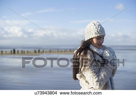 Picture - Young woman wearing knit hat, Brean Sands, Somerset, England. Fotosearch