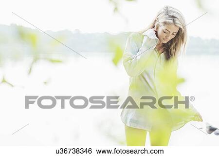 Stock Photograph - Young woman wearing shirt. Fotosearch