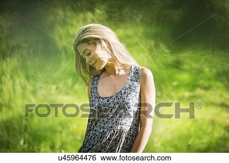 Stock Photograph - Young woman wearing sundress. Fotosearch