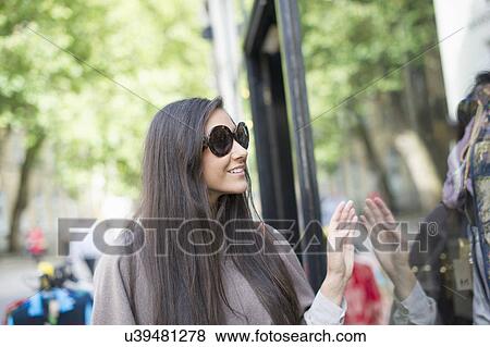 Young woman window shopping View Large Photo Image Stock Photo - Young woman window shopping. Fotosearch