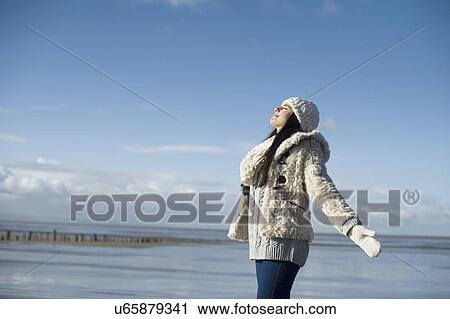 Young woman with arms out, Brean Sands, Somerset, England View Large Photo Image Stock Image - Young woman with arms out, Brean Sands, Somerset, England. Fotosearch