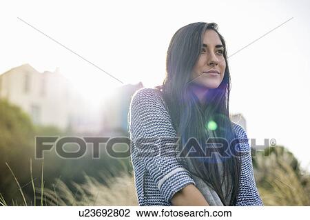 Young woman with long brown hair in sunlight View Large Photo Image Stock Image - Young woman with long brown hair in sunlight. Fotosearch
