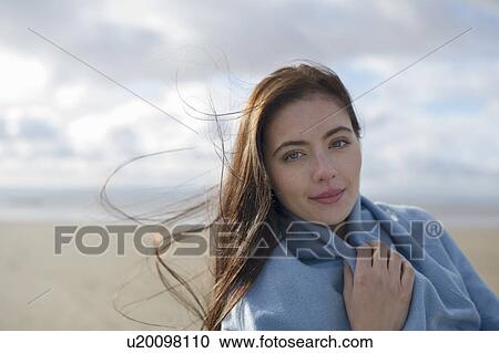 Young woman wrapped in blanket View Large Photo Image Stock Image - Young woman wrapped in blanket. Fotosearch