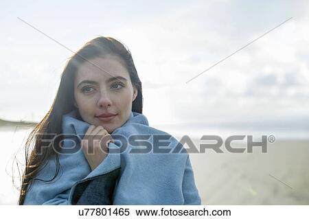 Young woman wrapped in blanket View Large Photo Image Stock Photography - Young woman wrapped in blanket. Fotosearch