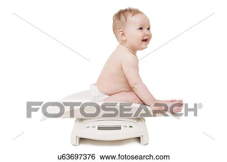 Baby being weighed View Large Photo Image Stock Photograph - Baby being weighed. Fotosearch