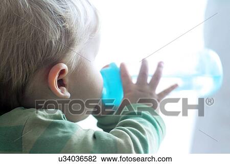 Baby boy drinking from bottle View Large Photo Image Stock Image - Baby boy drinking from bottle. Fotosearch