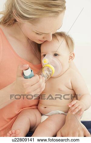Baby using an inhaler View Large Photo Image Stock Image - Baby using an inhaler. Fotosearch