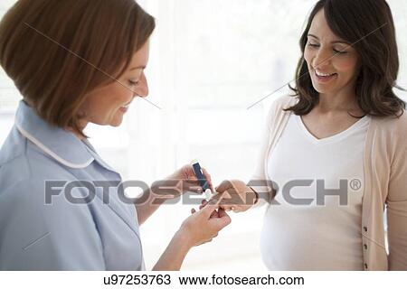 Stock Image - Blood glucose test in pregnancy. Fotosearch